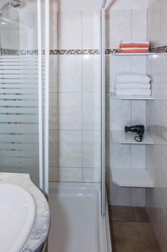 a white bathroom with a shower and a sink at Haus Saroja in Brand