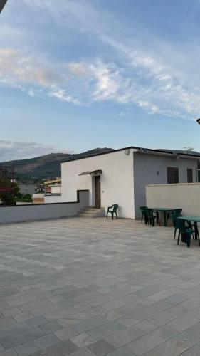 a building with tables and benches on a patio at Rifugio le Palme in Cervino
