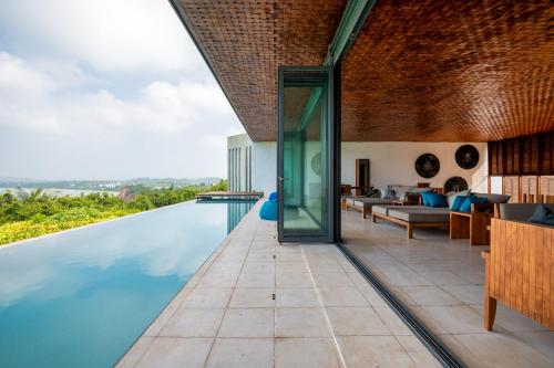 an infinity pool in the living room of a house at Villa Vista by The Serendipity Collection in Mirissa