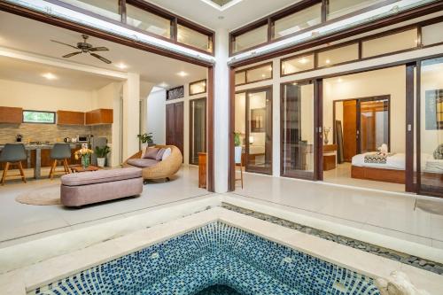 a home with a pool in the middle of a living room at Seven Residence in Seminyak