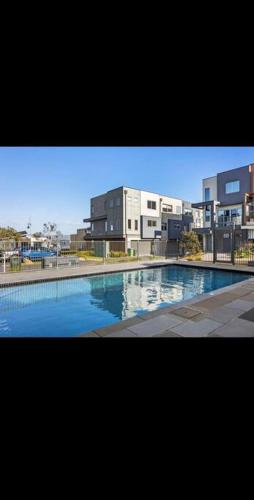 a large swimming pool in front of a building at Martha Cove Family Retreat in Safety Beach