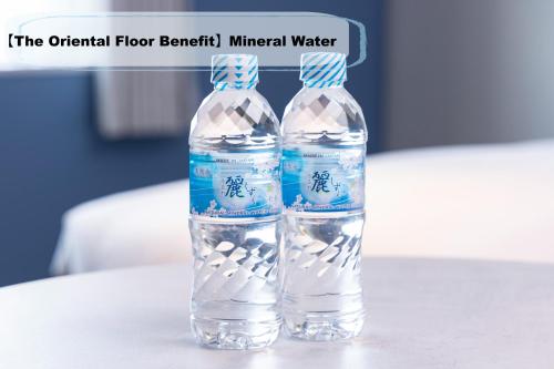 two bottles of water sitting on a table at Oriental Hotel Tokyo Bay in Urayasu