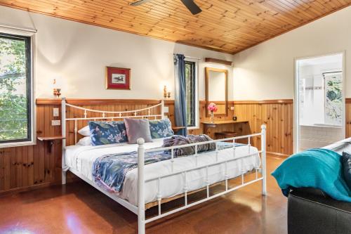a bedroom with a bed and a wooden ceiling at Montville Country Cabins in Montville