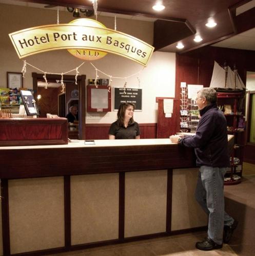 two people standing at a hotel port aux basques counter at Hotel Port Aux Basques in Channel-Port aux Basques