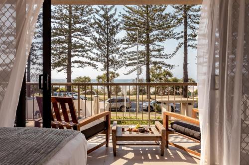 a bedroom with a balcony with a view of the ocean at Columbia Beachfront Apartments on Rainbow Bay in Gold Coast