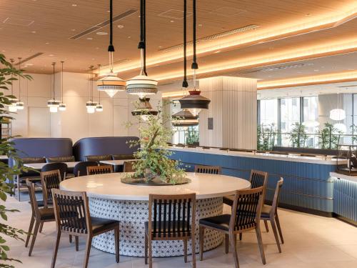 a dining room with a table and chairs at Nishitetsu Hotel Croom Hakata Gion Kushida Shrine in Fukuoka