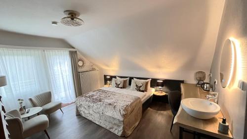 a hotel room with a bed and a sink at Harz hotel Iris in Sieber