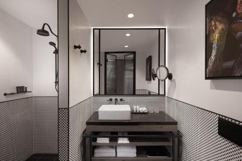 a bathroom with a sink and a mirror at Hotel X Brisbane Fortitude Vly, Vignette Collection by IHG in Brisbane