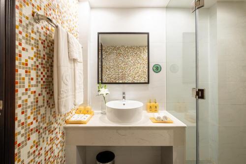 a bathroom with a sink and a shower at Sandals Lily Hotel in Da Lat