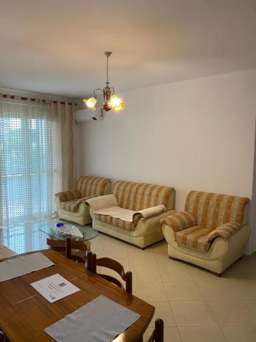 a living room with couches and a table at Emily House in Fier