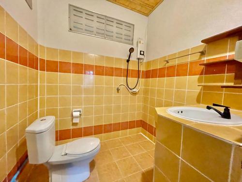 a bathroom with a toilet and a sink at Pyramid Yoga Koh Phangan in Koh Phangan