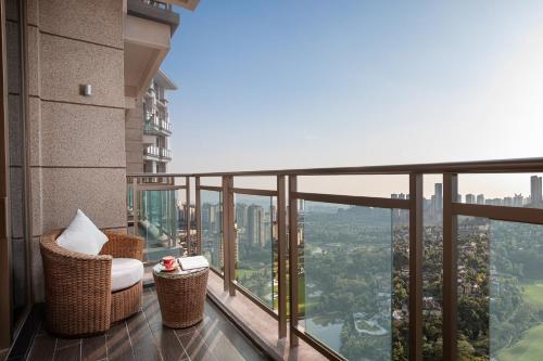 a balcony with chairs and a view of the city at Crowne Plaza Chongqing New North Zone by IHG in Chongqing