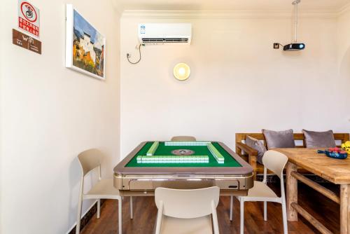 a dining room with a ping pong table at Guangzhou He She Art Apartment in Guangzhou