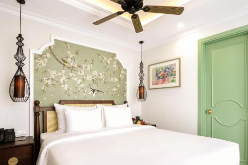a bedroom with a bed and a ceiling fan at Lestar Hotel Hanoi in Hanoi