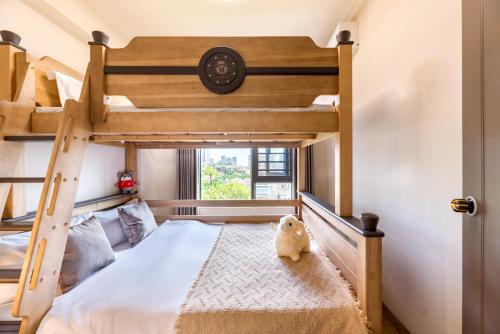 a bedroom with a bunk bed with a dog sitting on the floor at Guangzhou He She Art Apartment in Guangzhou