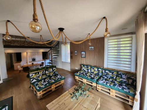 a living room with two couches and a table at L'escapade Romantique in Dreuil-lès-Amiens