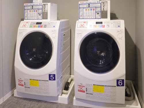 two washing machines are sitting next to each other at Hakata Green Hotel No.1 in Fukuoka