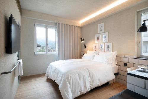 a bedroom with a white bed and a window at B5 Boutique & Design Hotel - Digital Check in - Adults Only in Lugano