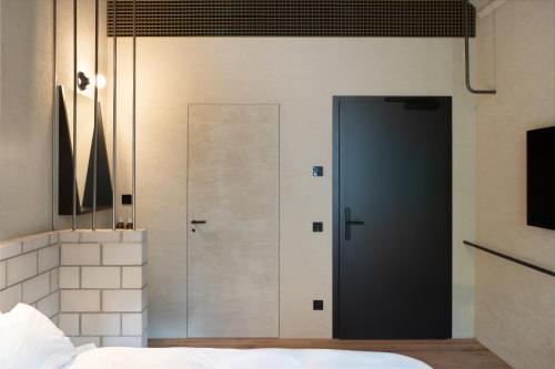 a door in a room with a bedroom at B5 Boutique & Design Hotel - Digital Check in - Adults Only in Lugano