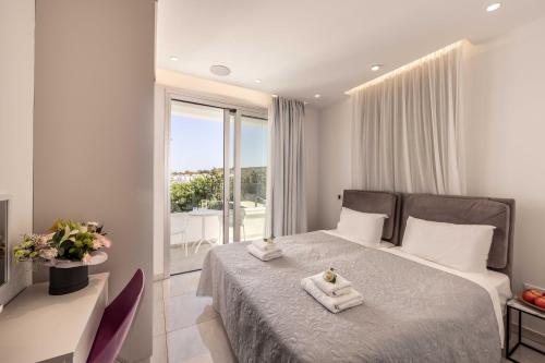 a bedroom with a bed with two towels on it at Villa Green Haven 2 Protaras Cyprus in Protaras