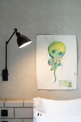 a painting of a skeleton on a wall next to a lamp at B5 Boutique & Design Hotel - Digital Check in - Adults Only in Lugano
