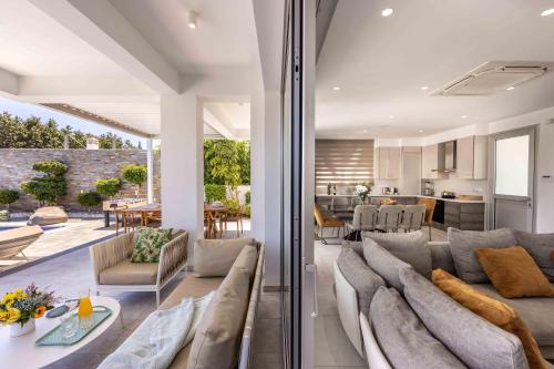 a living room with a couch and a dining room at Villa Green Haven 2 Protaras Cyprus in Protaras