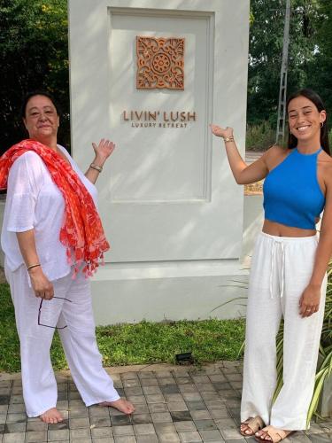 a man and a woman standing in front of a sign at Livin Lush Luxury Retreat in Anuradhapura