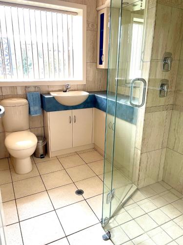 a bathroom with a toilet and a sink and a shower at Kangaroo Island Seabright House in Kingscote