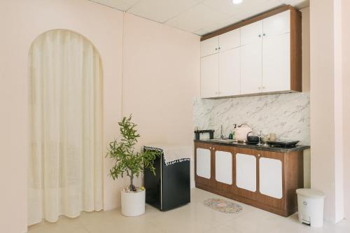 a kitchen with a sink and a shower in a room at Ann's Home in Hanoi