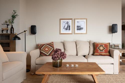 a living room with a couch and a coffee table at KRISTOMI Weinbergvillen in Oberburgstall