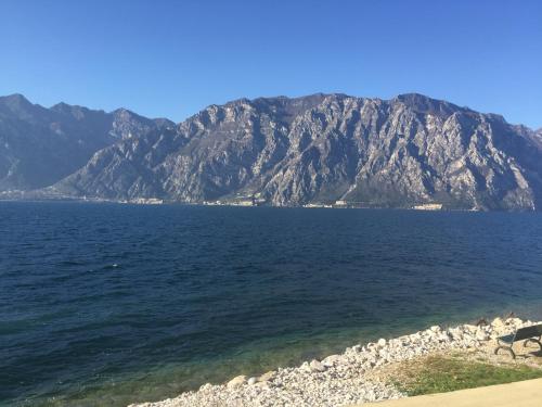a large body of water with mountains in the background at Hotel Vela Azzurra in Malcesine