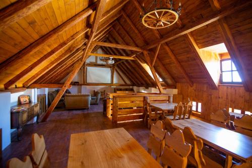 a dining room with wooden tables and chairs in a cabin at Statek Hostačov 