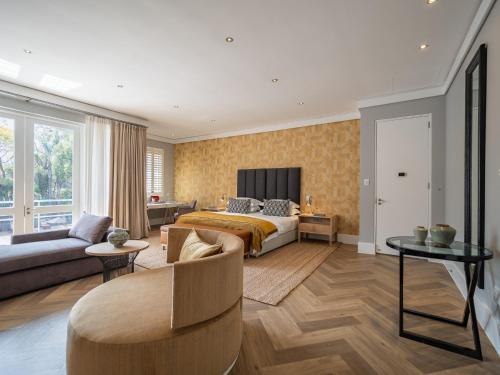 a bedroom with a bed and a living room at AtholPlace Hotel & Villa in Johannesburg
