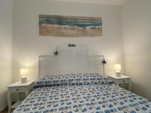 Un dormitorio con una cama grande con dos mesitas de noche. en Casa vacanze Li Marini, en Lido Marini