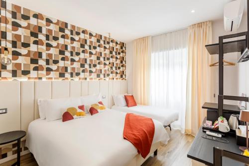 a hotel room with two beds and a desk at Romi Suite in Rome