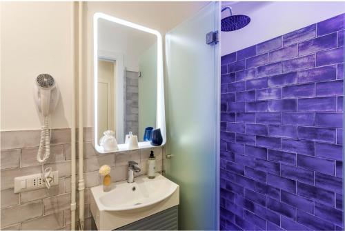 a bathroom with a sink and a mirror at Romi Suite in Rome