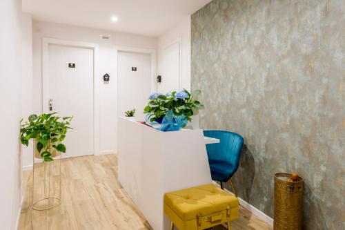 a hallway with a chair and a vase of flowers at Romi Suite in Rome