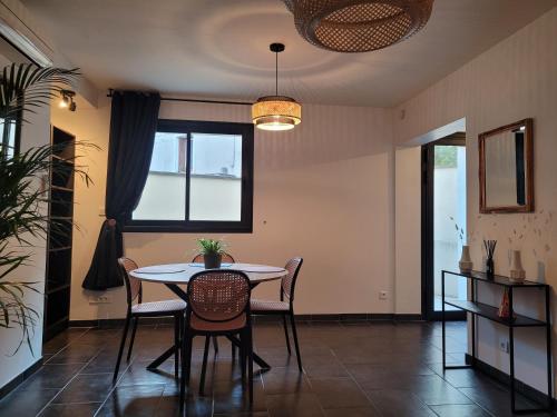 une salle à manger avec une table et des chaises et une fenêtre dans l'établissement Appartement cosy avec exterieur au coeur de la Provence, à Monteux