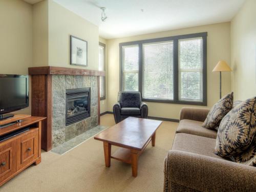 a living room with a couch and a fireplace at Panorama Mountain Resort - Premium Condos and Townhomes in Panorama