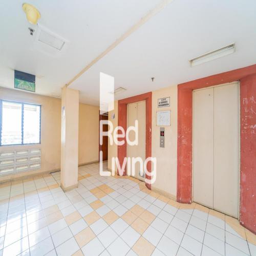 a room with a red living sign on the wall at RedLiving Apartemen Cibubur Village - Nadjla Property in Depok
