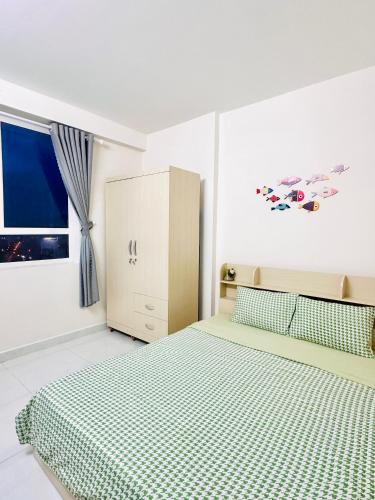a bedroom with a bed and a cabinet and a window at An's House In Phan Rang in Kinh Dinh