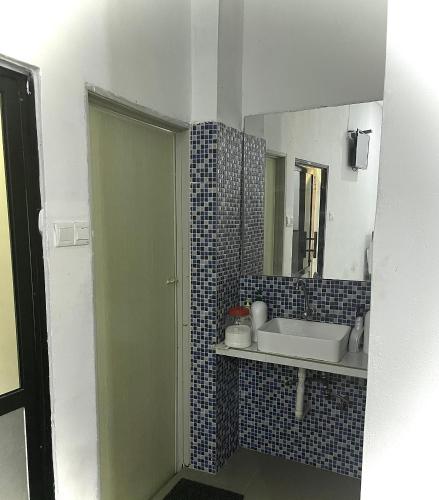 a bathroom with a sink and a mirror at Grand Star Hotel in Batu Ferringhi