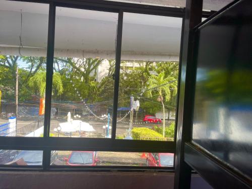a view of a playground through a window at Grand Star Hotel in Batu Ferringhi