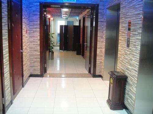 a hallway of an office building with a trash can at L'Arabia Hotel Apartments in Abu Dhabi