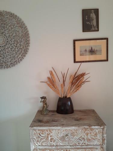 a vase sitting on top of a wooden table at The Seaglass Villas Bingin in Uluwatu