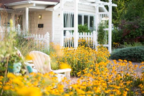 a garden with yellow flowers and a white fence at Somerset Inn & Suites in Ephraim