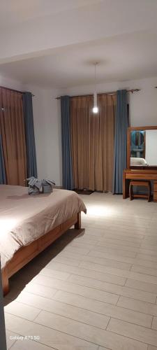 a bedroom with a large bed and a desk at Villa Chehara Bed n Breakfast in Grand Baie
