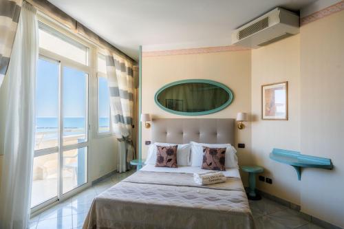 Posteľ alebo postele v izbe v ubytovaní Hotel Excelsior
