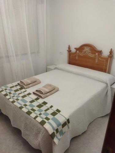 En eller flere senge i et værelse på Alojamiento caral