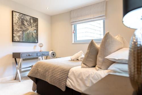 a bedroom with a bed and a window at Exclusive Cardiff City Centre Apartment in Cardiff